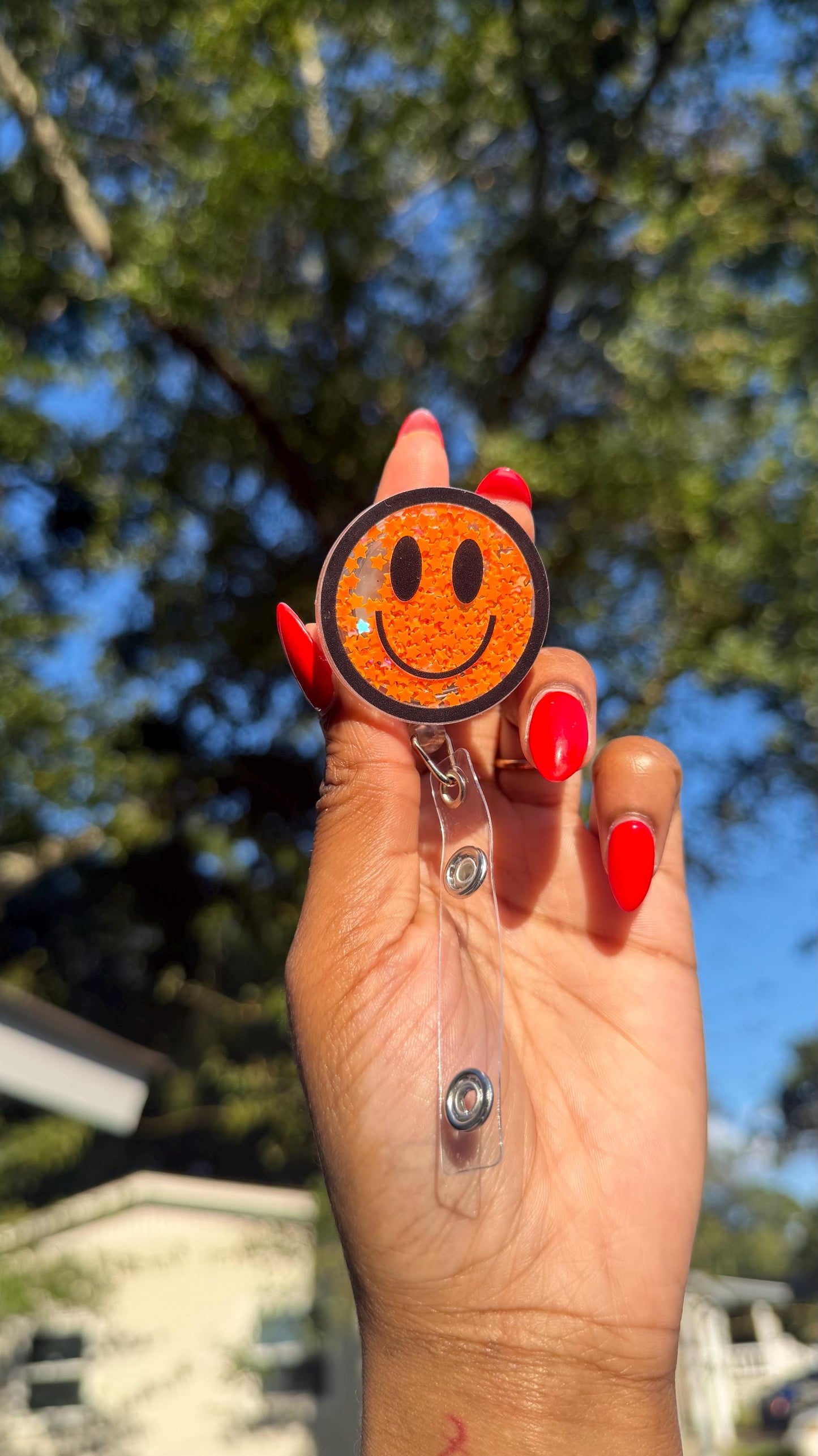 Orange Smiley Face Badge Reel