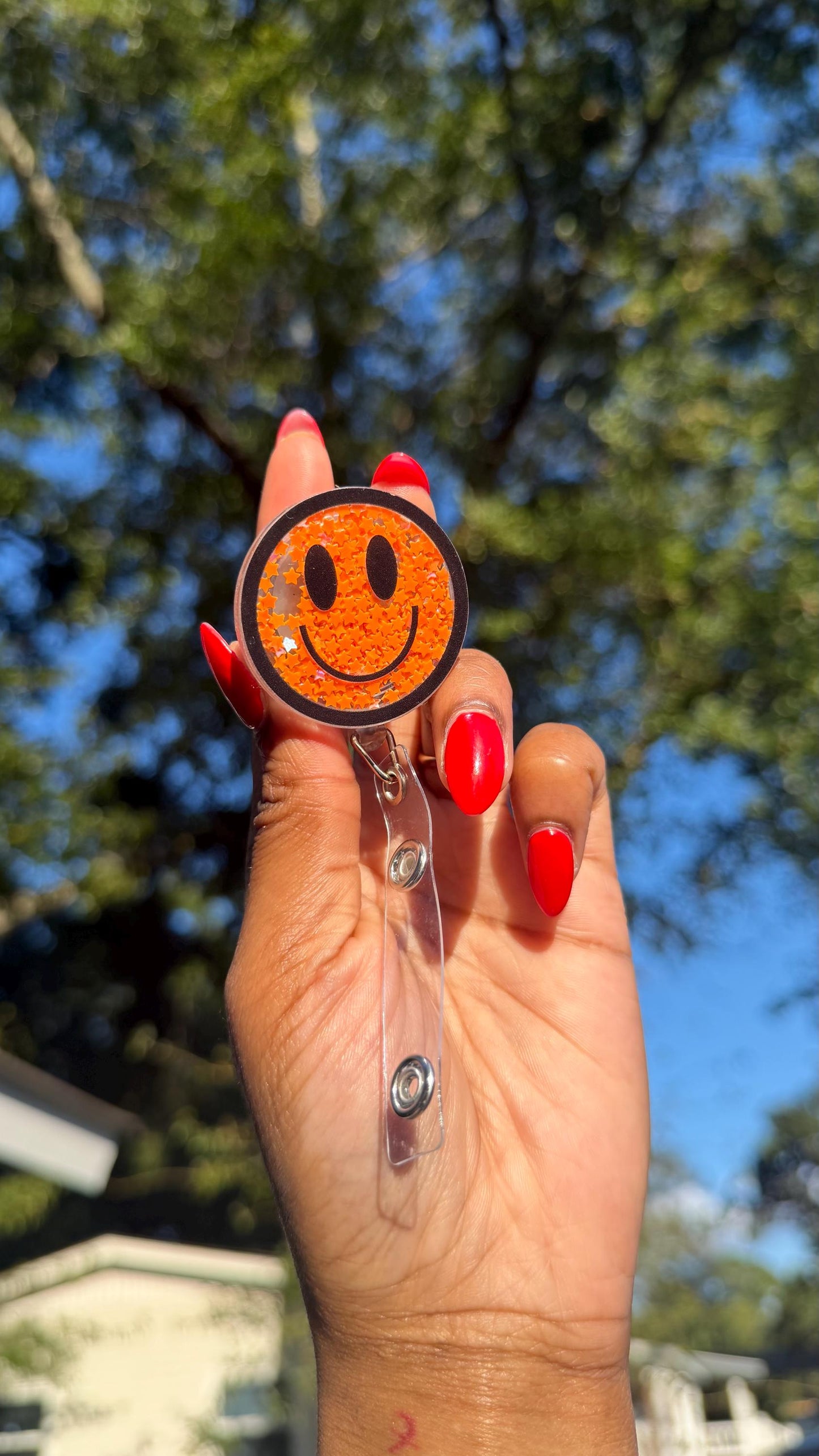 Orange Smiley Face Badge Reel